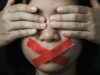 UGT Cultura rechaza el veto ideológico a las ayudas al cine en Castilla y León Mujer con los ojos cubiertos por sus manos y la boca sellada con cinta adhesiva roja, que simboliza la censura a la que se opone UGT Cultura.