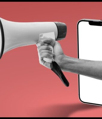 Publicis crece con la IA mientras aumenta la concentración publicitaria : Megáfono que emerge de un teléfono móvil, símbolo de la publicidad digital y de la concentración del sector en grandes grupos.